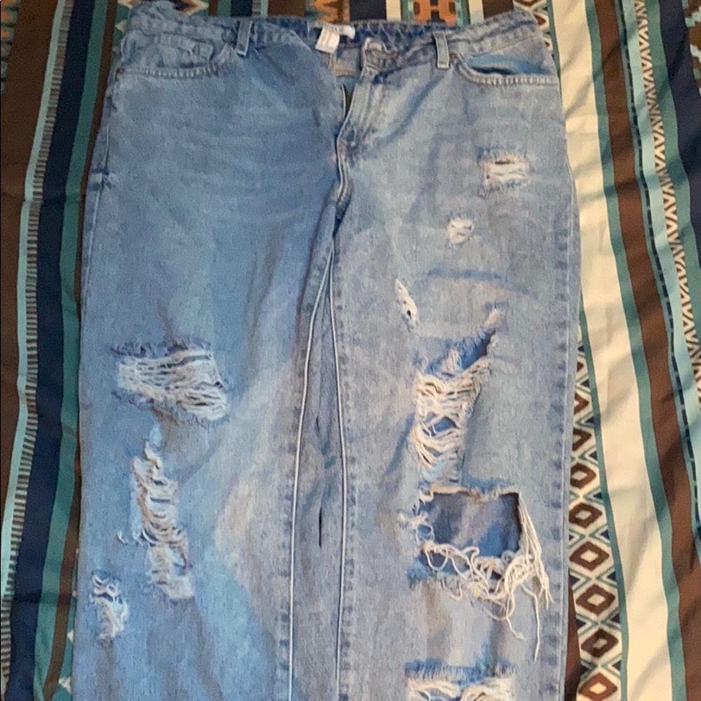 Light blue jeans with rips on front legs.